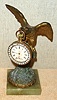 Ansonia Clock Co., New York, C.1900, "EAGLE" cast metal desk novelty, with 1-day watch size clock with brilliant studded bezel hanging from his beak.