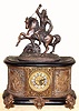Ansonia Clock Co., New York, C.1904, "VIRGINIA and DAGOBERT" figural clock, base with fancy cast brass dial, open 'scape, and with individual cartouche number plaques {royal blue Roman numerals}, 8-day, gong strike.