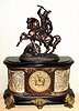 Ansonia Clock Co., New York, C.1904, "VIRGINIA and DAGOBERT" figural clock, base with fancy cast brass dial, open 'scape, with unique silvered over-lay mask which highlights the numerals. 8-day gong strike.