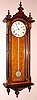 E. Howard and Co., Boston, REGULATOR No. 59, smallest size timepiece with 6" dial, weight driven, 8-day, C.1880, in a walnut case, glazed sides and with ebonized accents, three carved finials at bottom and 3 turned finials at top.
