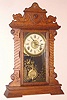 Seth Thomas Clock Company, Thomaston Conn gingerbread clock 8 day time, half hour strike and alarm spring driven mvt in oak case with Roman numeral signed dial, c1895