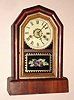 New Haven Clock Co., New Haven Conn. "OCTAGON PRIZE" mantel clock 30 hour, time and strike and alarm spring driven mvt in mahogany veneered case with Roman numeral painted zinc dial, c1878