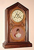 E. Ingraham, Bristol Conn. "DORIC No. 2" mantel clock 30 hour time and strike spring driven mvt in mahogany and rosewood veneered case with RN painted gilt pan dial and a tablet featuring a lovely decal transfered portrait of a striking young lady, c1874
