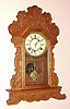 Waterbury Clock Co., Waterbury Conn. "FESTUS" model 8 day, time and strike spring driven mvt in oak case with Rococo gilt pan 6" dial, c1906