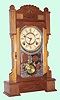 Wm. L. Gilbert Clock Co., Winsted, Conn. "CALPE" model 8 day time and strike spring driven mvt in walnut case with nickel plated 6" pan dial, c1885