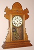 Waterbury Clock Co., Waterbury Conn. "FISHKILL" model 8 day time and strike spring driven mvt in oak case with gilt pan dial, c1890