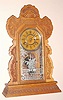 Ansonia Clock Co., NY. "LINDELL" model from Ansonia's "L" Assortment series with 8 day time and half hour strike spring driven mvt in carved oak case with nickel plated 6" dial pan, c1901