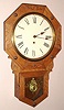 New Haven Clock Co., New Haven, Conn. "BLAKE" model 8 day time only spring driven mvt in oak short drop octagon case with applied carved trim pieces and RN paper over gilt pan 12" dial, c1900