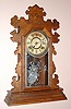 Ansonia Clock Co., Ansonia, Conn. "BERKELEY" model 8 day time and strike spring driven mvt in carved walnut case with Roman 6" nickel plated pan dial, c1894