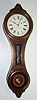 E. Howard and Co, Boston, "REGULATOR No. 10", figure 8 wall clock, in a walnut case with reverse painted tablets, invar pendulum rod, eight day, serial No. 331, C.1976, along with its framed certificate of origin, dated Nov 1, 1976 and signed by D. J. Blackwell. Consigned by the original purchaser, H. Newman.