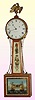 Elmer O. Stennes, Weymouth, Mass, banjo timepiece, mahogany cross-banded case, weight driven 8-day with a naval battle scene from 1812; this clock No. 12 of 1968. Dr. Newman drove to Weymouth and purchased this clock in Nov. '68, prior to Elmer murdering his wife on Dec 2, 1968; he drove back the following year and purchased the Stennes lyre banjo that is also in this sale.