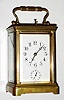 French, Brass Cased Carriage Clock, Petite Sonnerie [strikes ding dong quarters and repeats quarters and hours, with a silence lever in the base], also w/ alarm, top bearing a presentation engraved for year 1904, and with carry case w/ latched lid.