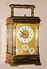 Carriage clock French with Petite and Grande Sonnerie, quarter hour repeat, alarm and day / date calendar 8 day spring driven movement with platform lever escapement in Anglais Riche case with Corinthian columns surmounted by fancy capitals with Arabic numeral porcelain chapter rings on time dial, alarm dial and both calendar dials, c1900