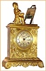 J. Charles a' Paris French gilded brass figural time only spring driven mvt with figure of Rembrandt working at easel with ship's scene on canvas and Roman numeral silvered dial with subsidiary seconds at 12, c1850 sNo. 6263
