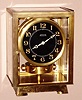 French, J.L. Reutter ATMOS clock, atmospheric driven time only movement with torsion pendulum designed using mercury inside a glass tube similar to that of a thermometer to react to sensitive changes in temperature and atmospheric conditions, Arabic numeral radium painted black dial, sNo. 3705 c1926