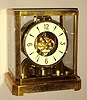LeCoultre "ATMOS" perpetual running clock 15 jewels, wound by changes in temperature and pressure, mov't visible through gilt brass and glass case; sNo. 112604 c1958
