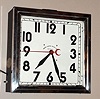 Neon Clock Sales Co. Chicago, Ill. advertising clock with electric Synchron movement in painted sheet metal case with chrome bezel and Arabic numeral dial with sweep seconds hand and reddish / pink neon lights, c1960