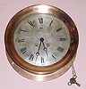 Chelsea Clock Co., Circa 1903, 8-day time and ship's bell strike CHELSEA model wall clock, serial no. 7209, 8.5" dial, red brass case with hinged bezel with button latch.