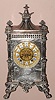 Ansonia Clock Co., "ELITE", cast metal mantel clock, finished in nickel-silver, and with Ansonia's fanciest visible escapement, the 'scape wheel supported by two winged griffins, and the Roman numerals on individual porcelain cartouches, c.1904