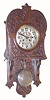 German, Art Nouveau wall clock in oak, with fancy floral pattern dial center and matching pendulum, with a quality solid plate / cut pinion mov't with dead beat escapement. Open well or "Berlin" style case with free swinging pendulum, pressed floral patterns repeated on the door.