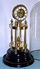 French, unusual mantel regulator, the silk thread movement mounted atop a 4-column temple style stand, under a glass dome, 8-day bell strike.