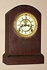 Ansonia Clock Co. New York, U.S.A. "HARWICH" model 8 day time and strike spring driven No. "6 1/2" movement in mahogany veneered case with Roman numeral porcelain 4" dial with exposed escapement, c1914
