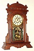 New Haven Clock Co., walnut gingerbread clock, with cathedral gong and indicator pendulum, C.1885