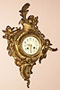 French, E. B. Serin, Paris, a brass cased hanging cartel clock in the Louis XVI style with a winged cherub either side of the dial, C.1870, mov't signed with Serin trademark "Qualite Soignee" logo.