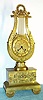 French, Lyre Form mantel clock, c.1830, silk thread suspension, in an ormolu lyre frame with gilt brass base. The mov't with rear adjust for F/S. Gilt dial with painted Roman numerals.