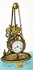 Parker Clock Co., Meriden, Conn, , C.1890, "No. 11" desk timepiece, 1-day, in a well made cast brass case, a trinket tray at bottom, and the clock hanging from 2 chains.
