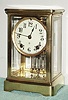 Ansonia Clock Co., CRYSTAL model 4-glass mantel regulator with 2-vial pendulum and solid creamy porcelain dial.