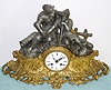 French, cast metal figural clock with a gilt base, two 17th century combatants, clothed in chain mail, resting between battles, with a silk-thread, bell strike movement.