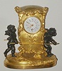 French, c.1880, novelty mantel clock in the form of a gilt sedan, carried by two winged cherubs in black finish, and with a small round movement with platform, serial No. 3678.