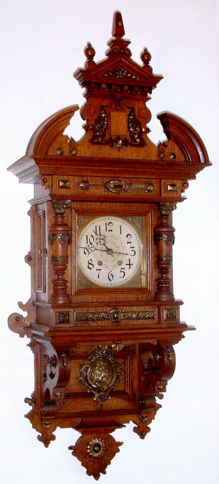 German, Lenzkirch, oak cased open well or "Berliner" style wall clock, 8-day time and strike, with fancy cast pendulum and many bronze trimmings. c1890, serial #952536 — Antique Clocks Price Guide