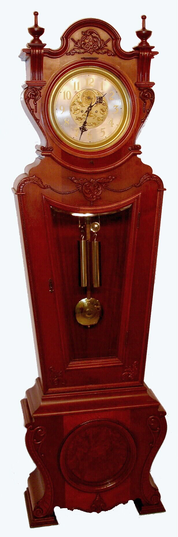 Waterbury Clock Co, rare floor standing Regulator No. 62, in a mahogany case with unusual keystone shape, quality 2-weight striking mov't and silvered dial with raised brass numerals and fancy center. — Antique Clocks Price Guide
