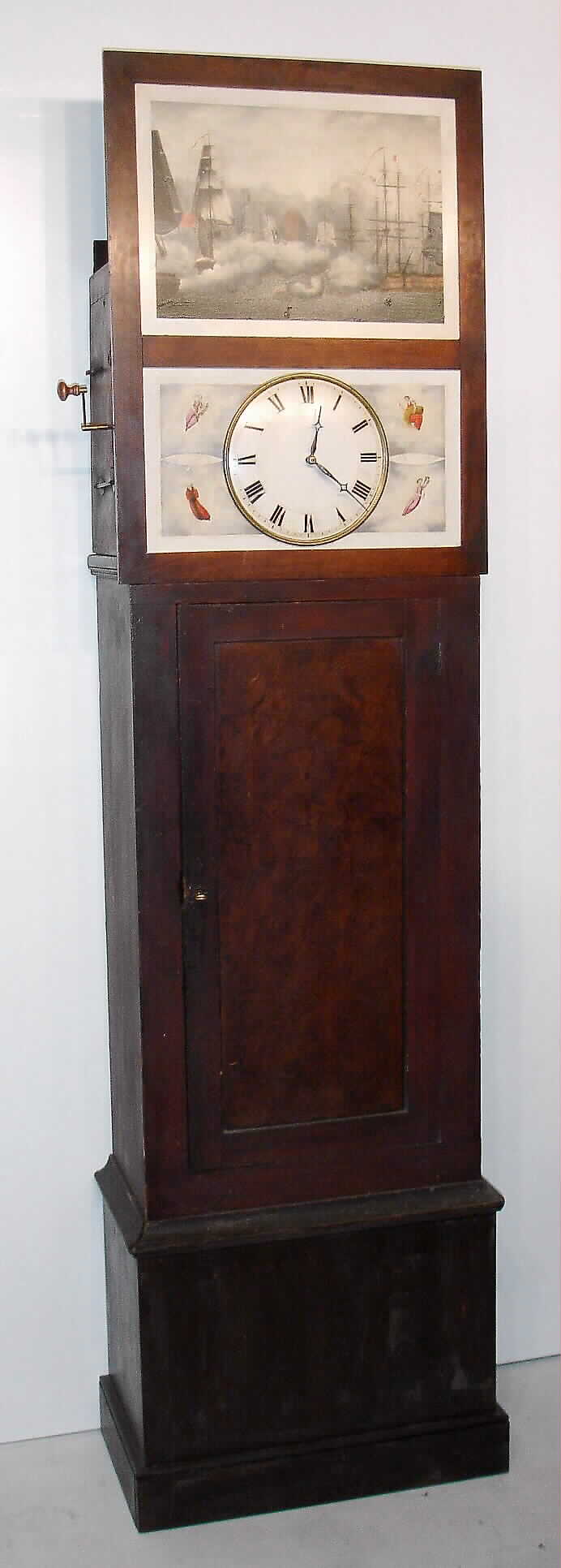 German tall case "organ or flute clock", 3-piece dial with painted scene of naval battle above round metal dial, time and strike weight driven movement in grain painted case with faux-grain burled door, 8-tune c1850 — Antique Clocks Price Guide