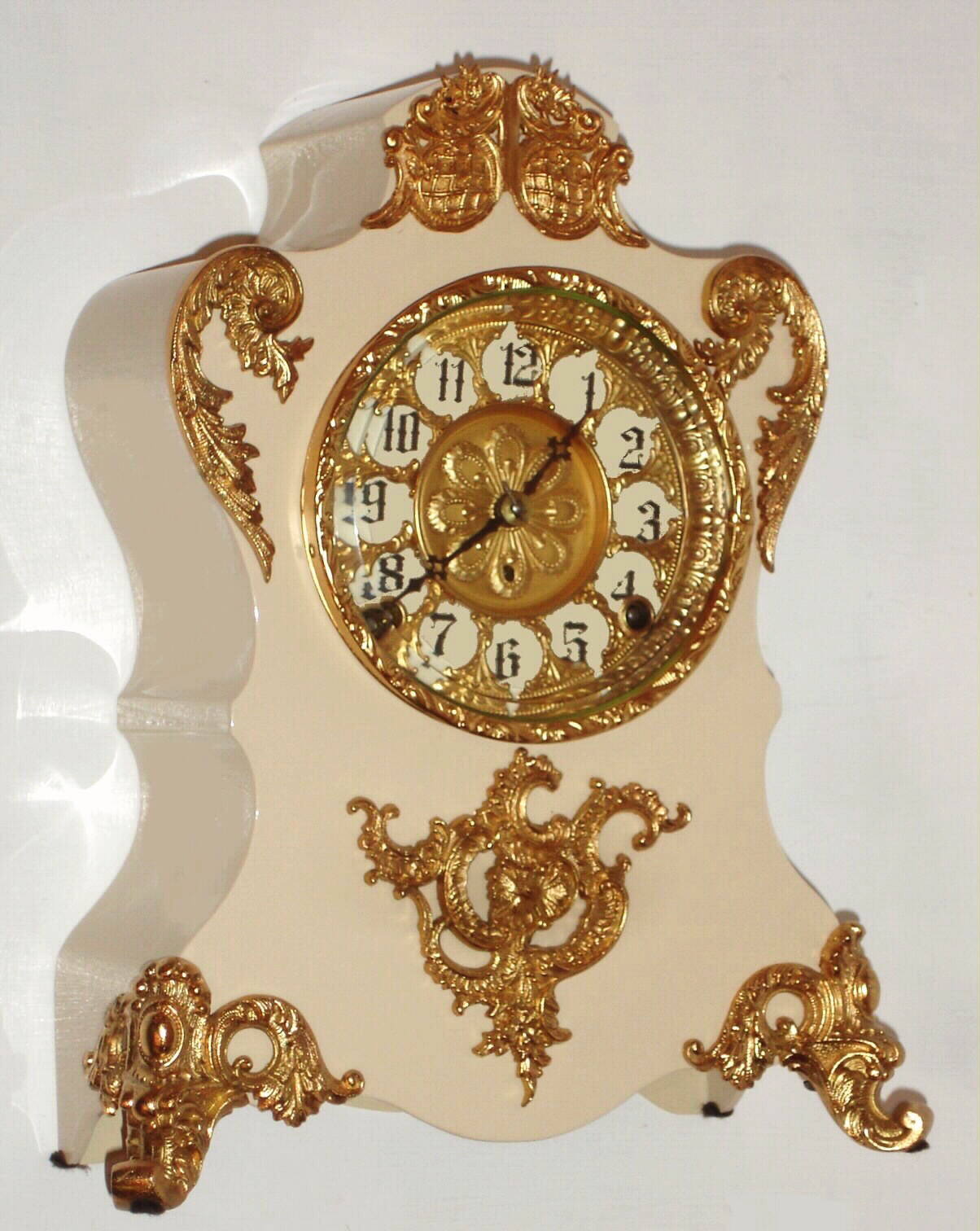 F. Kroeber Clock Co., New York, "Voltaire" mantel clock 8 day time and strike spring driven movement in white enamel over iron case with fancy cast trim and beveled glass, c1895 — Antique Clocks Price Guide