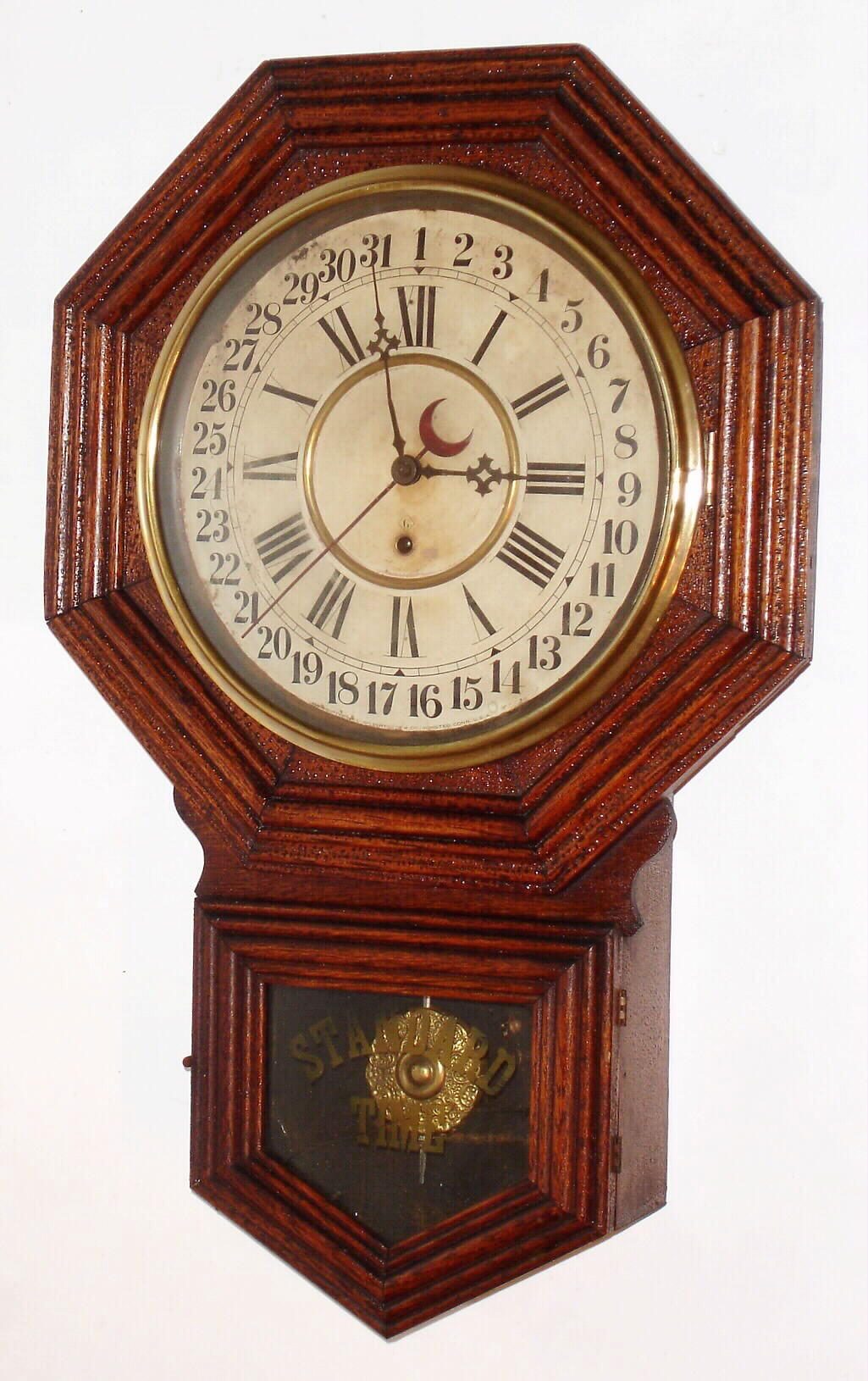 Wm.L. Gilbert Clock Co., Winsted, Conn., "No. 3027" oak "Octagon Drop" time and calendar short-drop school clock, C.1910. — Antique Clocks Price Guide