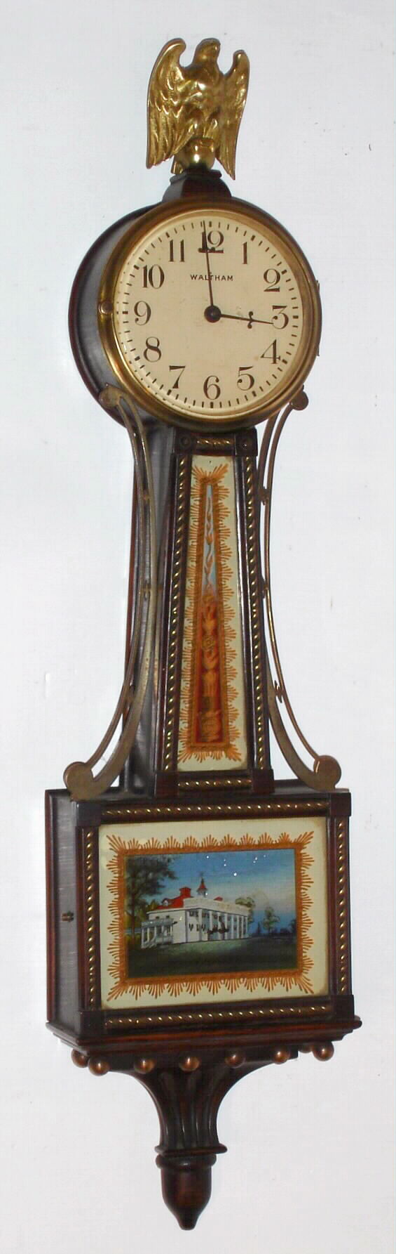 Waltham Clock Co., Waltham, Mass., "No. 1555" miniature banjo wall clock 8 day time only back wind spring driven movement in mahogany rope front case with reverse painted throat and lower tablets, c1930 — Antique Clocks Price Guide