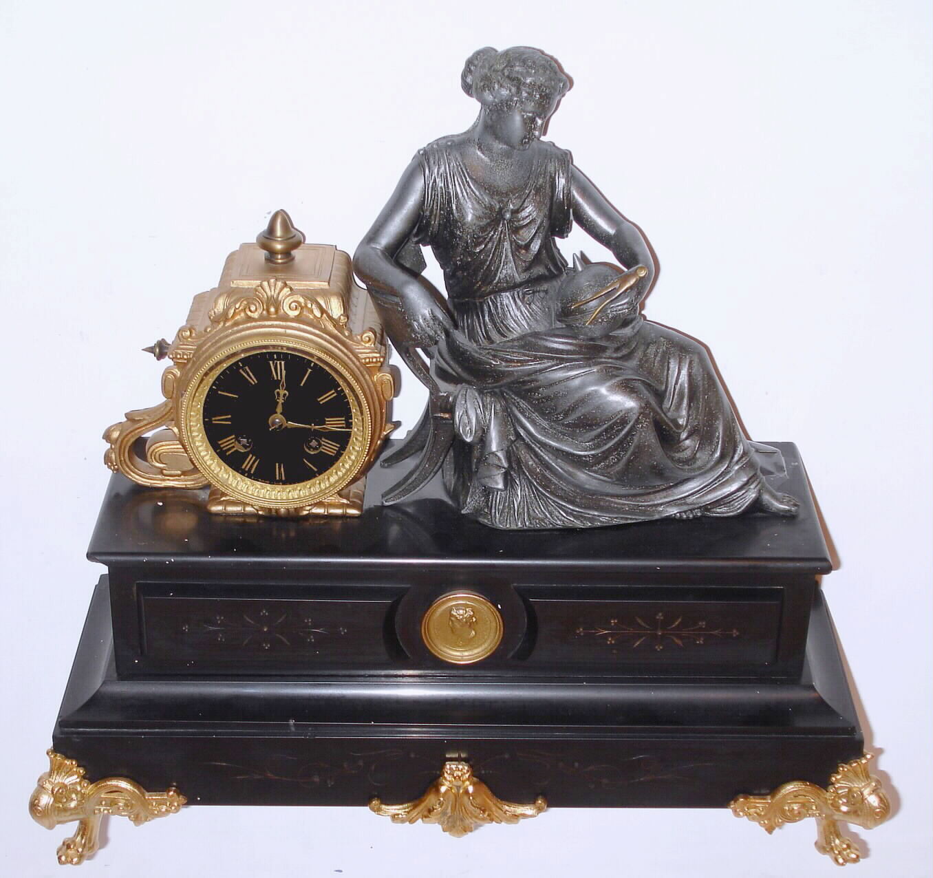 French figural of Urania, the goddess of astronomy, mantel clock with 8 day time and strike on bell, pendulum movement in spelter casting on slate base, c1890 — Antique Clocks Price Guide