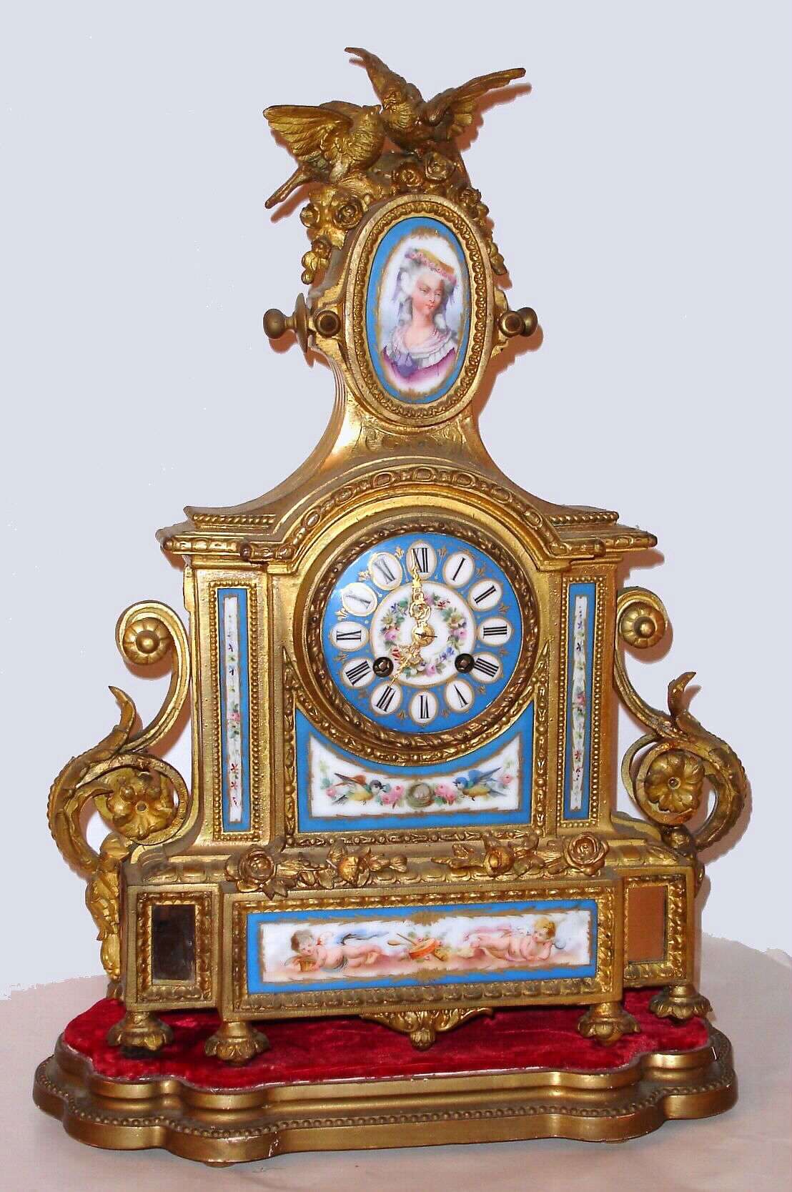 French mantel clock with 8 day time and strike on bell movement in gilt spelter case, set with Sevres type porcelain painted panels and dial on wooden conforming base, c1880. — Antique Clocks Price Guide