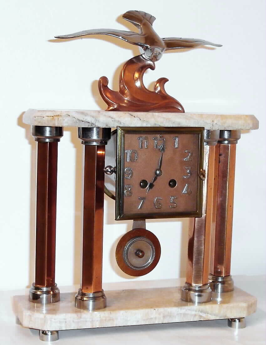 French Art Deco mantel clock with 8 day time and strike on bell spring driven movement in marble top and base case with bronzed pillars and surmounted by a bronze statue of a seagull signed "Decoux", c1925 — Antique Clocks Price Guide