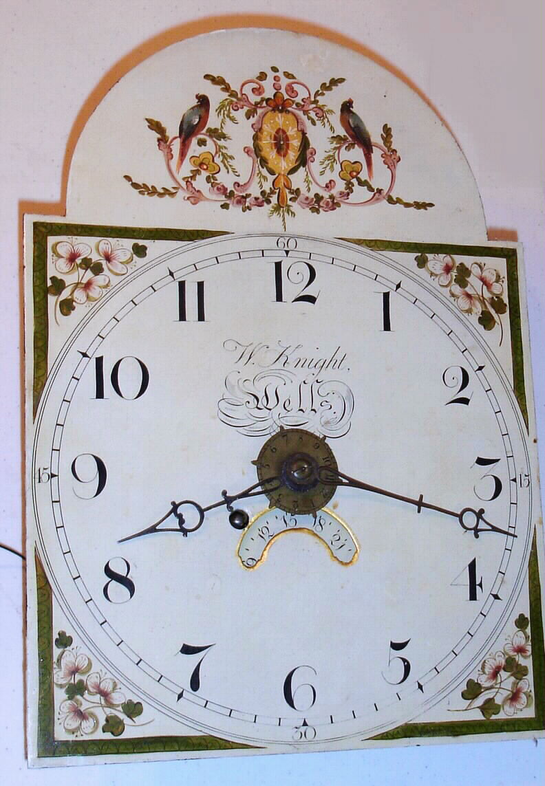 W. Knight, Wells, England, 8-day tall cased alarm timepiece, single weight driven movement only with a pull chain/ rope alarm, dial measures 11 wide by 15" high. C. 1820 — Antique Clocks Price Guide