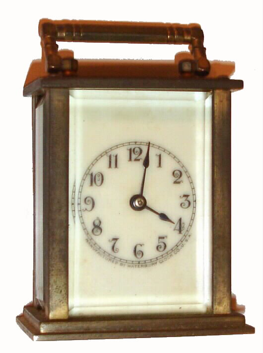Waterbury Clock Co., Conn. "Speck", 30-hour carriage timepiece, brass case, ivory colored porcelain dial. C. 1910 — Antique Clocks Price Guide
