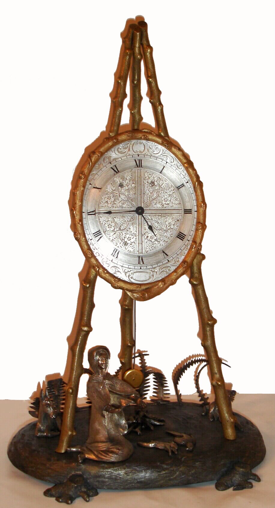 In the style of Thomas Cole, London, C.1850, figural group fitted with a French silk thread suspension movement. Gilt brass cast branches and an engraved silvered dial. Silvered cast figures. — Antique Clocks Price Guide
