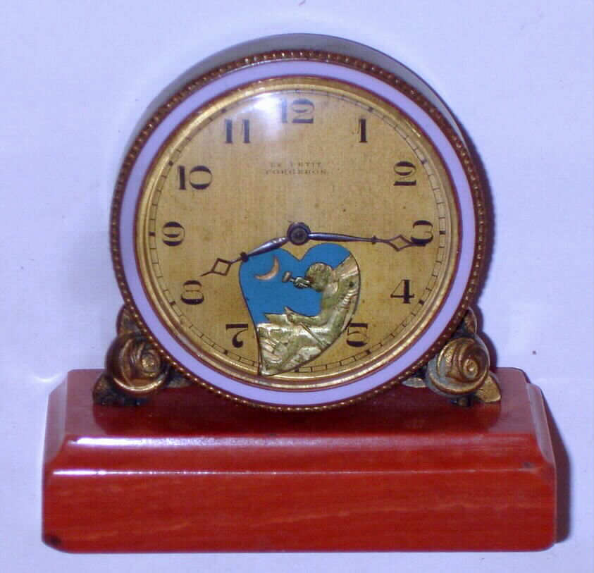 Swiss "Le Petit Forgeron", 30-hour watch with an automaton dial of cupid pounding on an anvil making arrows set on a marble base, C.1910 — Antique Clocks Price Guide