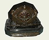 Art Nouveau French marble and bronze table clock 8 day time and half hour mov't strikes on bell, in Egyptian motif marble case with bronzed dial and silvered baton hands and hour markers flanked by bronze serpents and figures of Ra and supported by a tortoise, c1915
