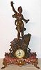 French, patinated spelter and marble figural clock of a "Car", a stylized version of a C.1900 motor car with steering wheel, with a statue of a flower girl standing on the car, the car mounted to a large rectangle of red and pink variegated marble, and the original title plaque "Fete de Fleurs". With a quality 8-day movement and porcelain dial.