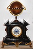 Edouard Serin, Paris, Globe Clock world time, a 5.5" globe with a brass equator ring showing 24 hours, 1-12 in red and 1-12 again in black, and with a rotating Halifax moon dial and scale showing the age of the moon in days.