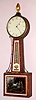 Banjo attributed to Simon Willard 8 day weight driven time only movement with Willard's distinct T-bridge suspension and fillister retaining screws in mahogany case with cross banded veneer accents and side arms, c1815